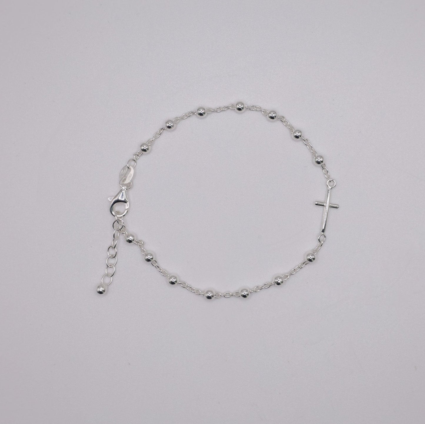 Silver bracelet on a light gray background
