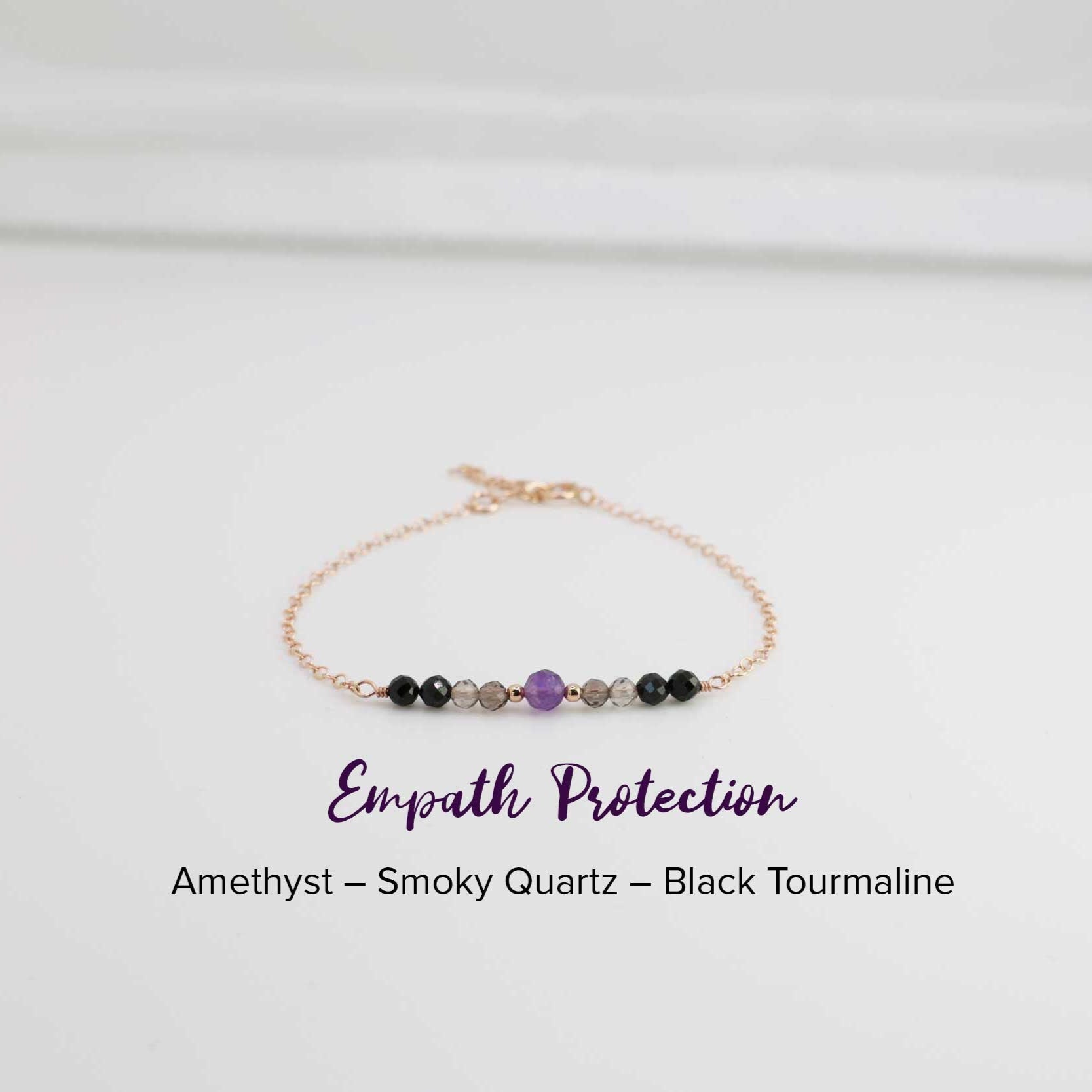 Dainty Empath Protection Bracelet with a 4 mm Amethyst stone in the middle, 2 mm  gold accent balls, smoky quarts, and black tourmaline healing crystals. The combination of these crystals makes a perfect protection for all empaths.