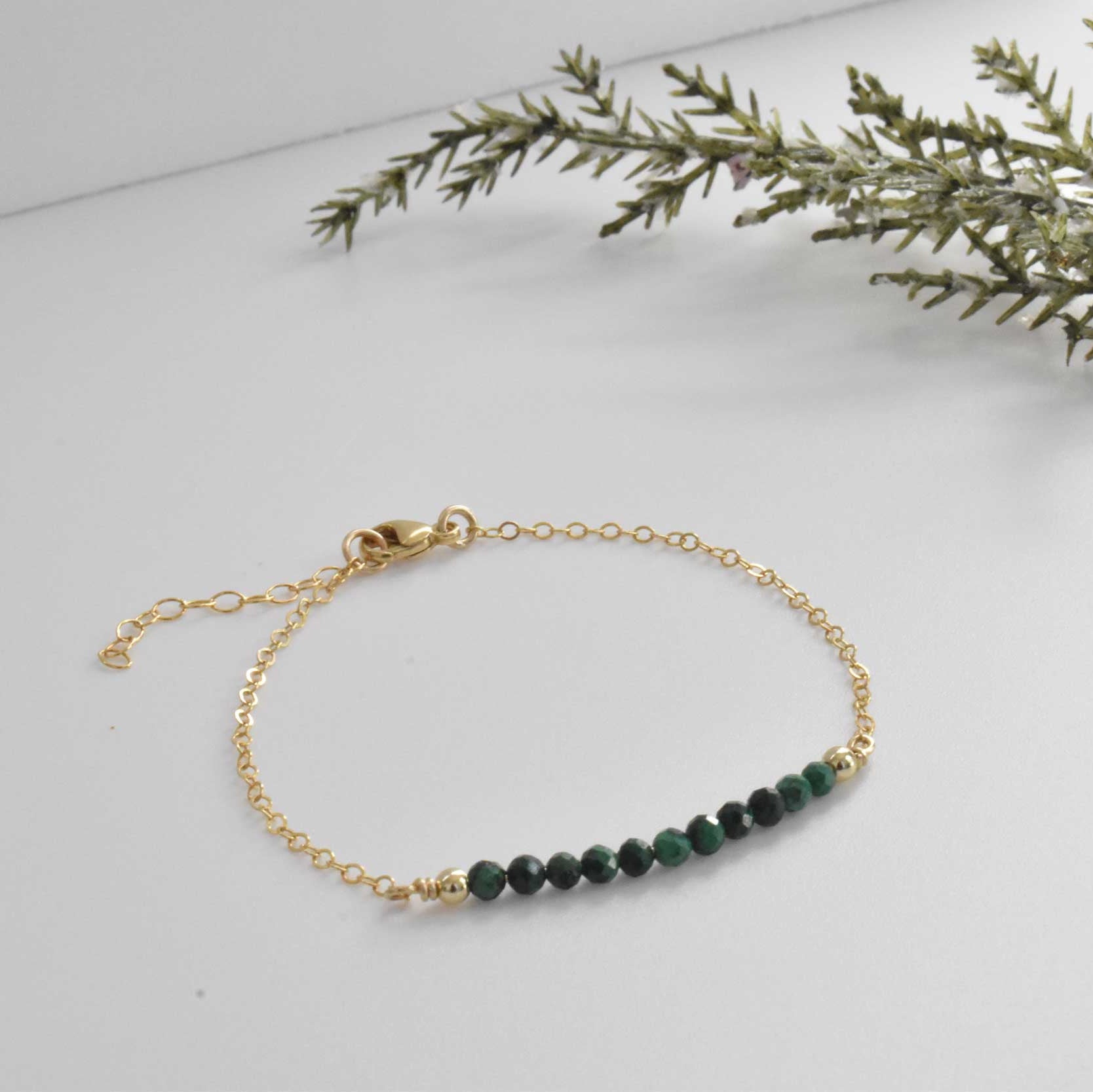 Dainty malachite healing crystal bracelet with dainty gold filled chain and yellow gold filled beads.