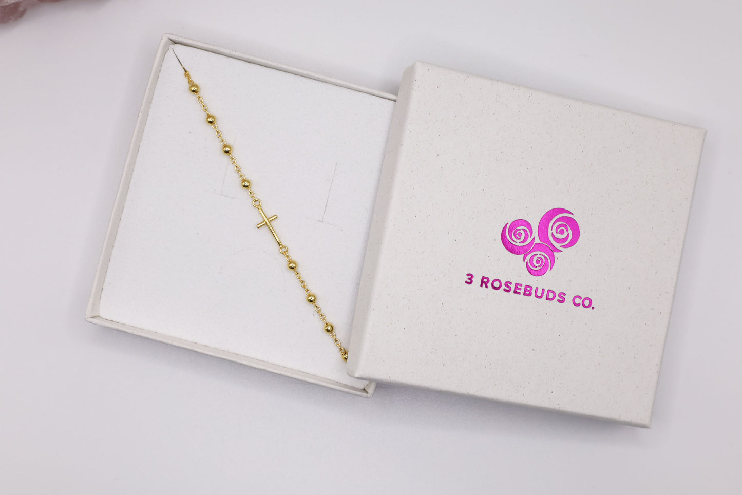 Gold cross bracelet in a gift box with 3 Rosebuds Co. logo – elegant religious gift for women, minimalist faith bracelet for special occasions.