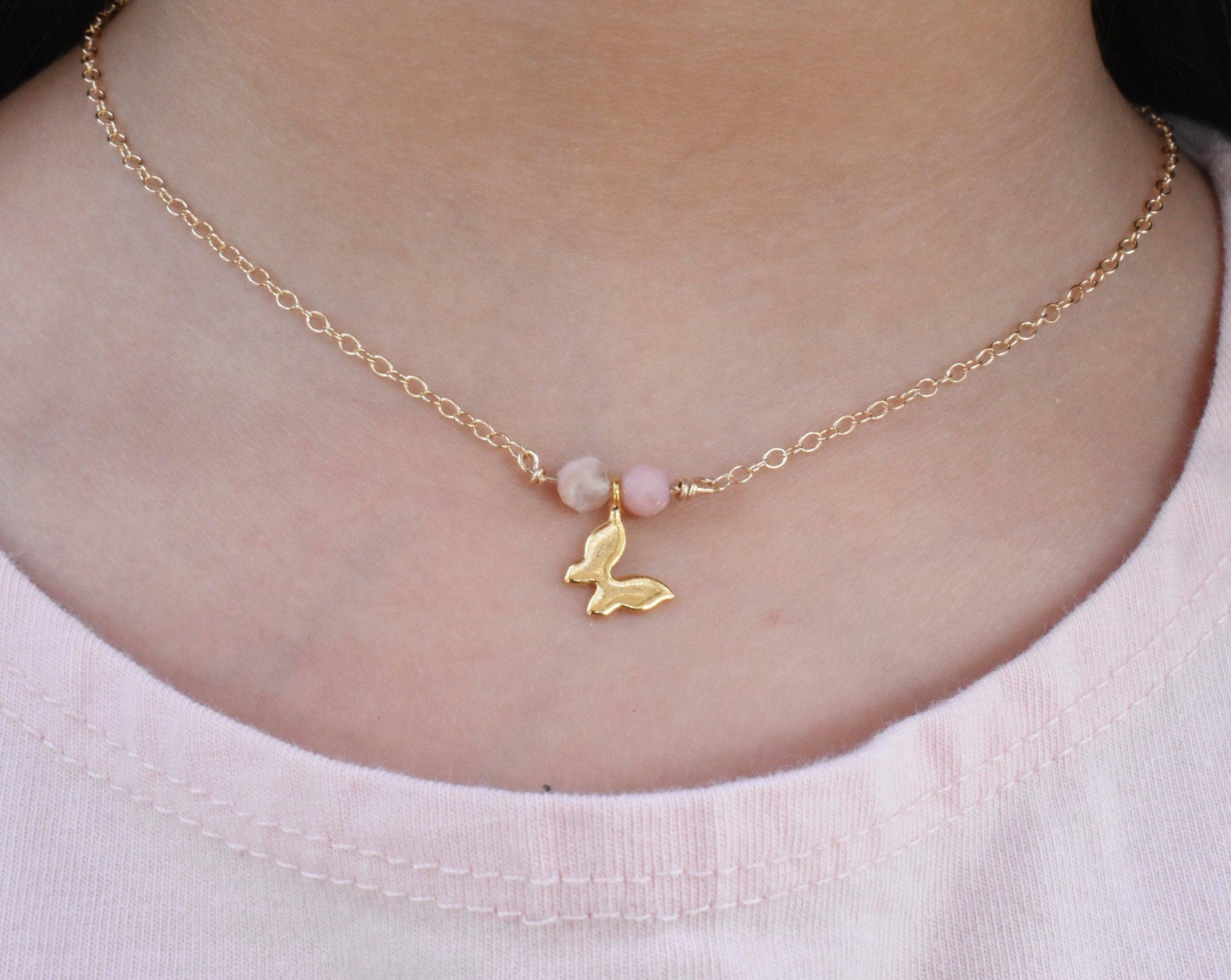 Dainty children's butterfly necklace with choice of pink opals or amethyst gemstones. This necklace is part of the children's collection. It features a gold-filled chain and your selection of semi precious healing gemstone crystals that are ideal for children for their soothing energy.