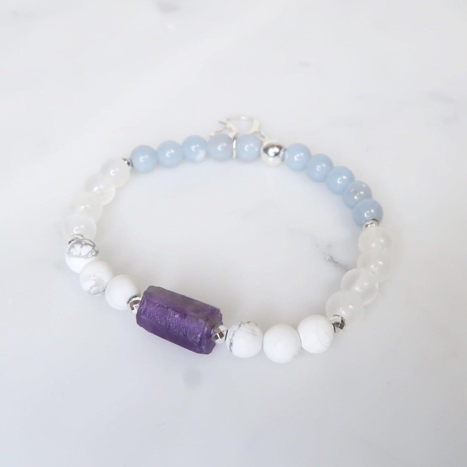 Reiki Infused Healing Gemstone Bracelet to Help you Connect with Your Angels & Guides. Featuring Amethyst, Angelite, Selenite, Howlite and an Angelic Charm to remind you that your team is always by your side. 