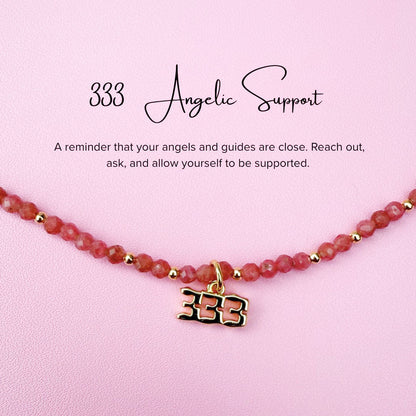 Pink tourmaline Necklace with '333' angel number charm on a pink background with text about angelic support.