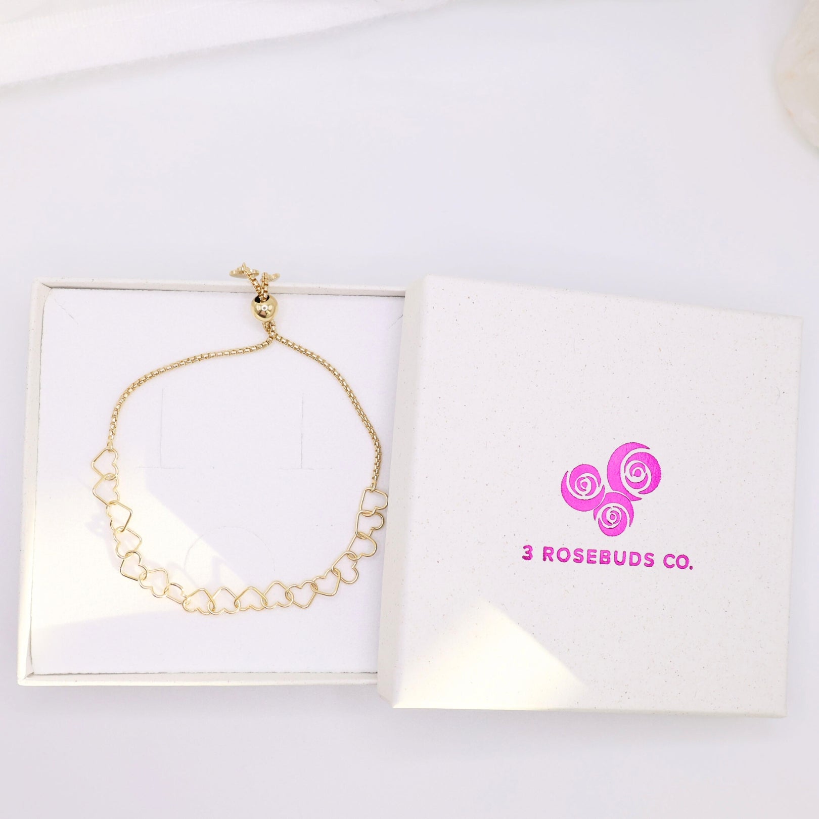 Adjustable heart bracelet in gold and featured in 3 rosebuds packaging.