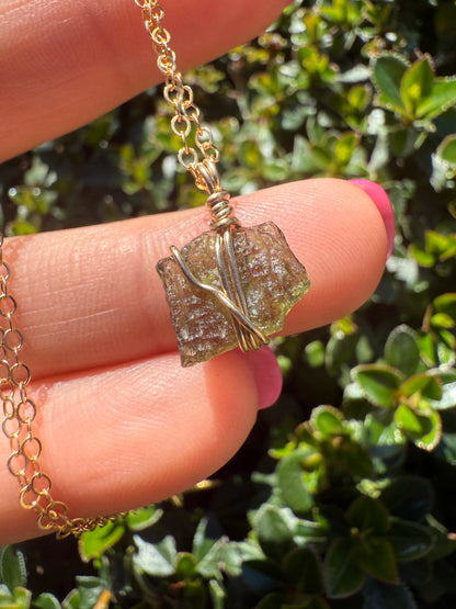 Raw moldavite wrapped in 14k gold filled wire and a 14k gold necklace
