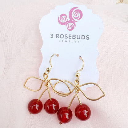 Handcrafted gold wire earrings with carnelians as cherries. Asymmetrical cherry earrings. 