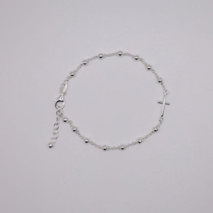 Silver bracelet on a light gray background