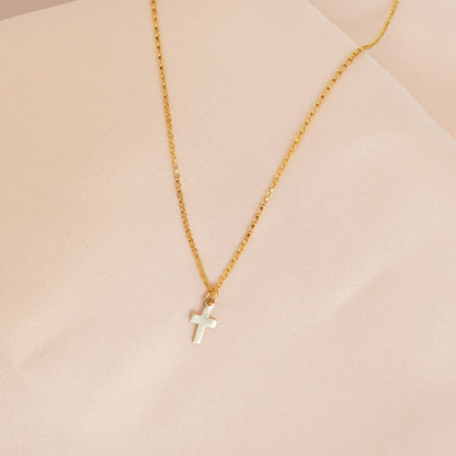 Gold Necklace with a cross pendant for girls on a pink background