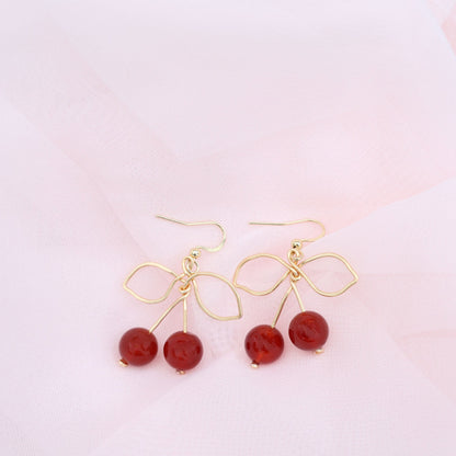 Gold Wire Cherry earrings featuring carnelian crystals as cherries. 