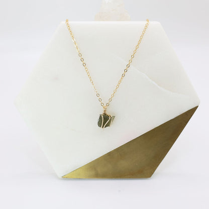 Authentic moldavite pendant wrapped in 14k gold filled wire and a delicate gold filled chain necklace. 