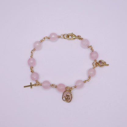 Rose quartz  rosary beaded bracelet with gold religious charms. 