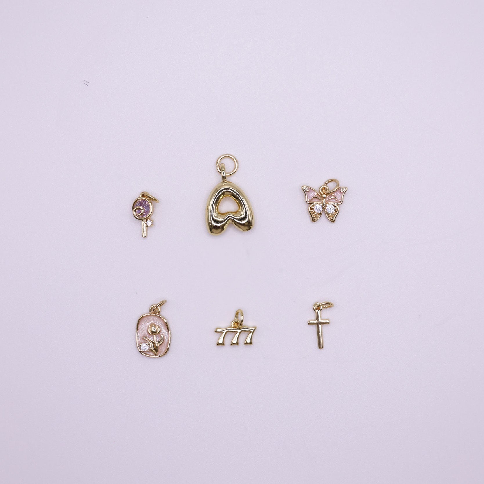Set of gold charms on a  white background
