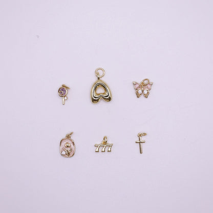 Set of gold charms on a  white background