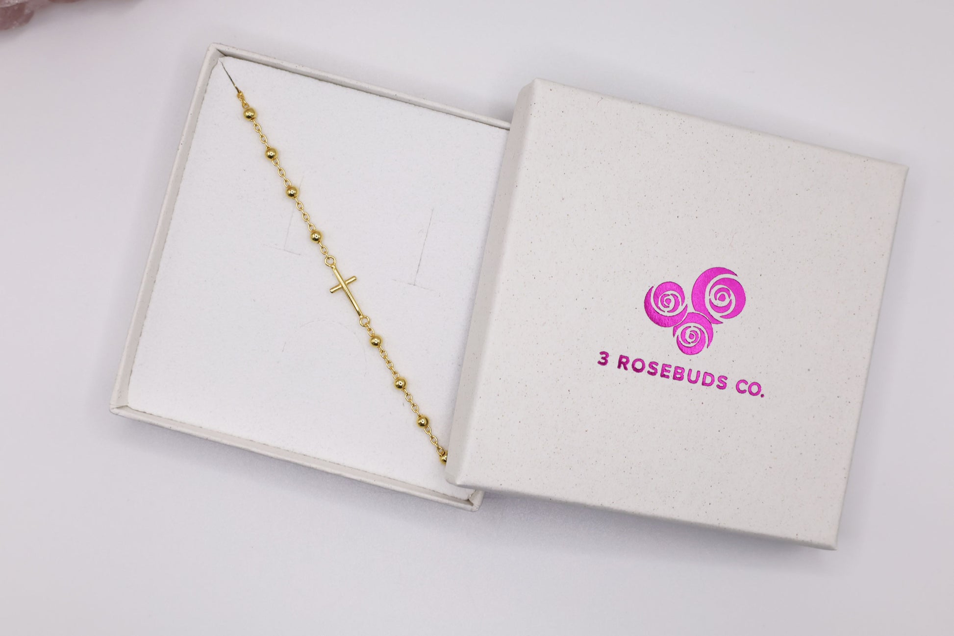 Gold cross bracelet in a gift box with 3 Rosebuds Co. logo – elegant religious gift for women, minimalist faith bracelet for special occasions.