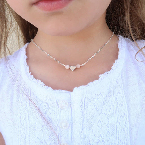 Children's healing gemstone heart necklace featuring pink opal for gentle love. 