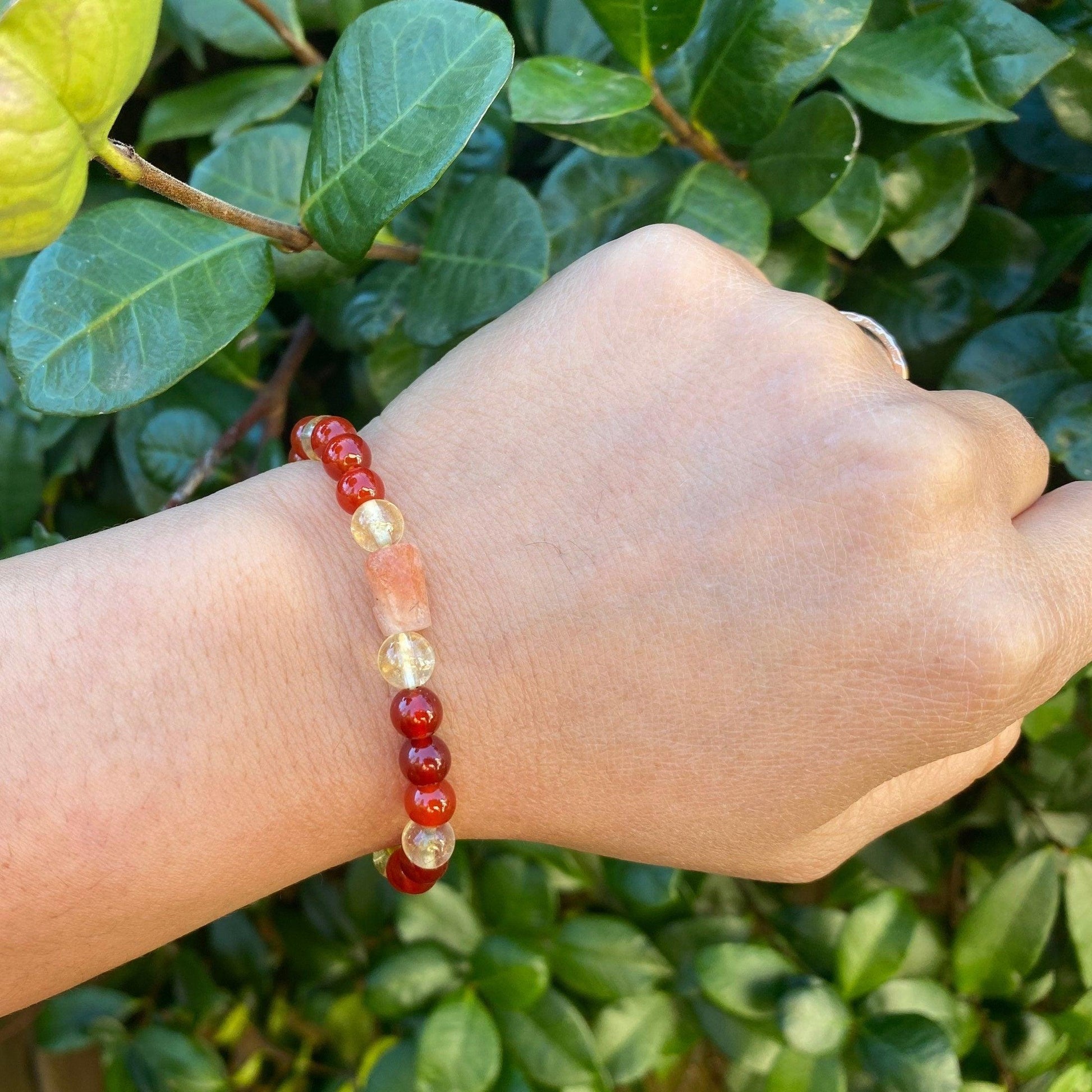 Phoenix Rising offers protection against the evil eye for Solar, Sacral, and Root Chakra healing. It includes Carnelian, Citrine, Sunstone, and Garnet, all infused with Reiki healing energy. - 3Rosebudsco.com 3Rosebudsco.com