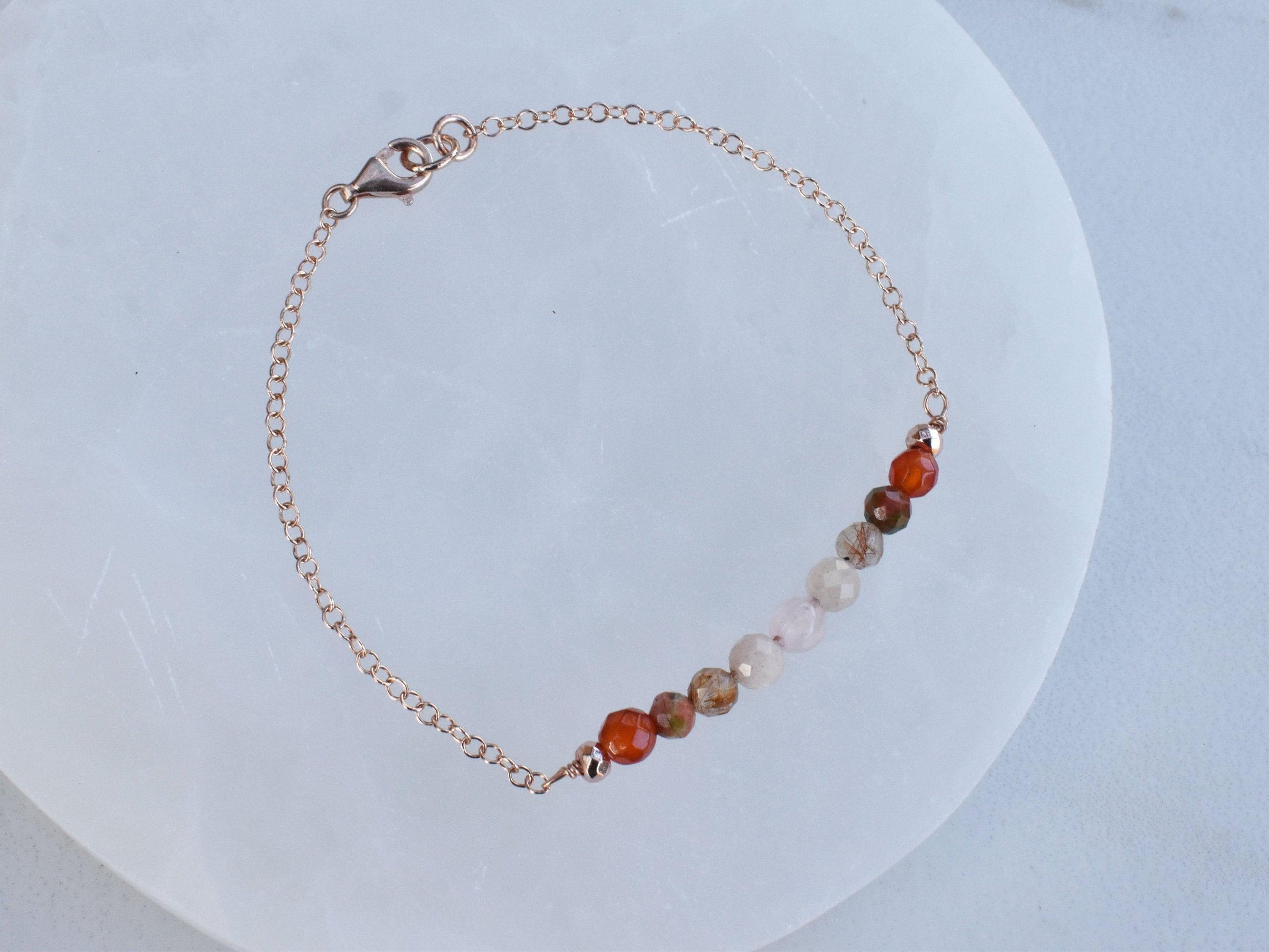 Dainty healing gemstone bracelet to help you on your fertility, and pregnancy journey. It features the top fertility crystals such as peach moonstone, unakite, carnelian, rose quartz and rutilated quartz.